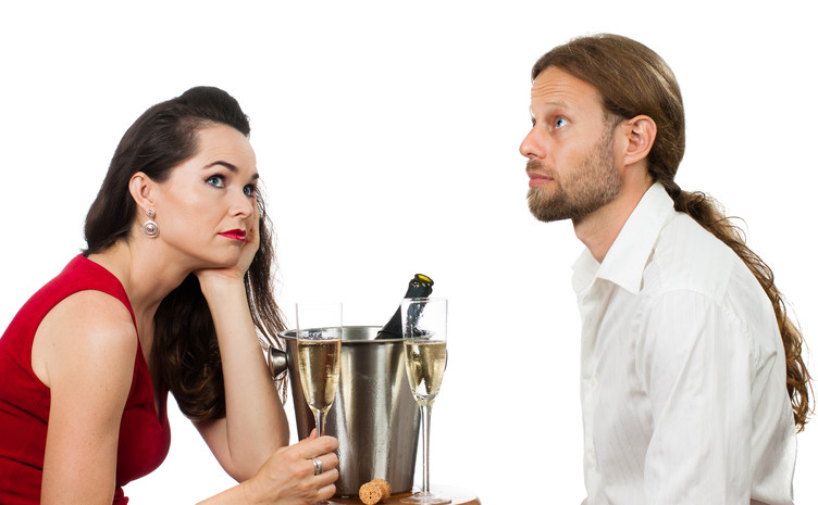 Man avoiding eye contact with woman at dinner
