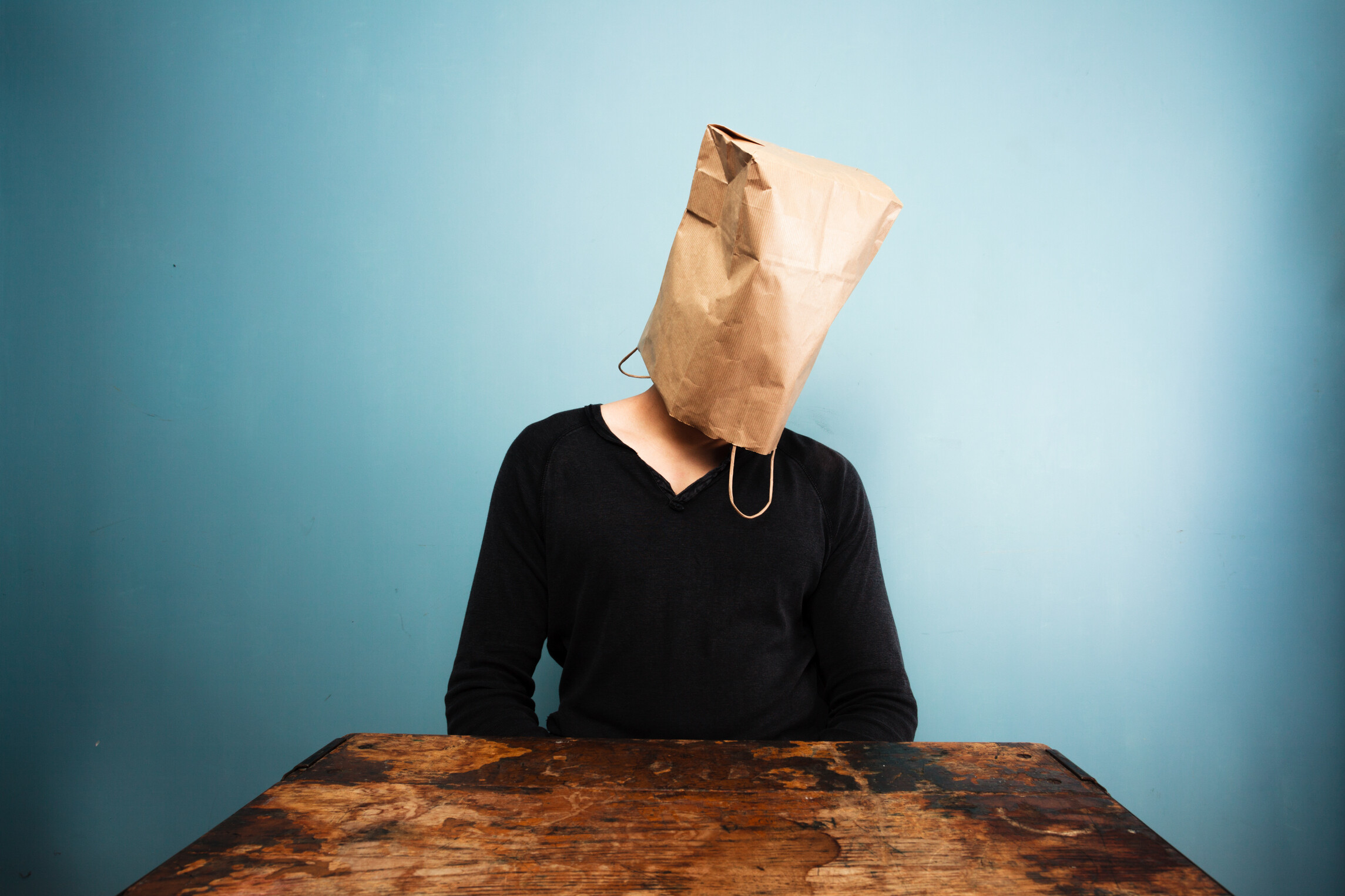 Man with paper bag over his head