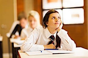 girl at school looking off into the distance with a distracted look
