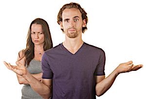 woman frowns at man who looks clueless