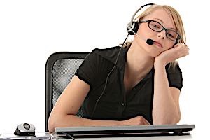 Bored telemarketer woman sitting at office computer