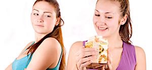 envious woman stares at happy woman opening a gift