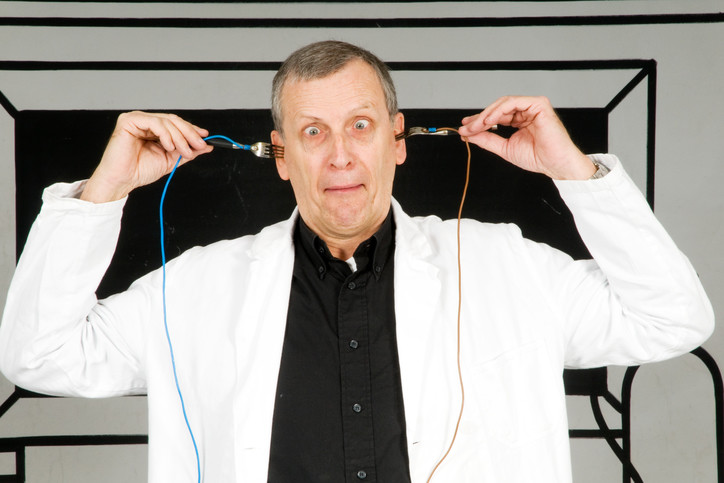 crazy man putting wires into his ears