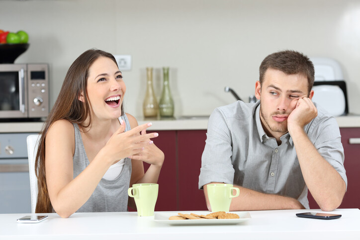 man is bored by eagerly talking woman