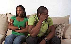 Angry woman sitting next to unfaithful husband