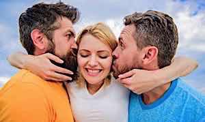 happy woman kissed by two angry men