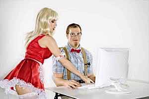 sexy woman in santa costume teases nerdy man at computer