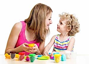 smiling child and single mother playing