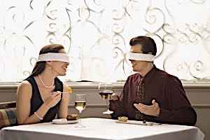 blindfolded man and woman on a dinner date