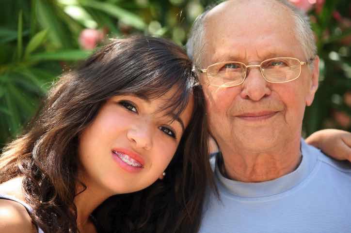 Woman posing with much older man