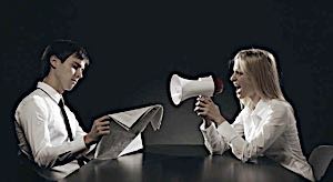 man reading paper ignoring his wife