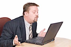 man having online romance and throwing a kiss into his computer screen