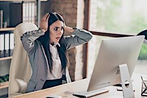 surprised woman viewing computer screen