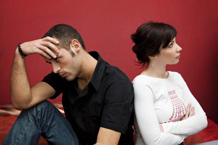 sad man and angry woman after discovery of an affair infidelity