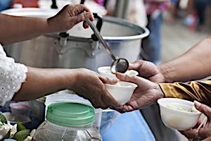 woman serving at soup kitchen