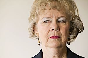 senior woman glancing sideways with critical look