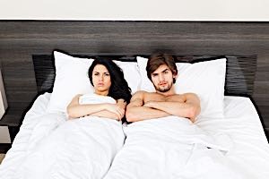angry man and angry woman in bed