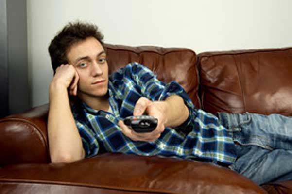Lazy man on couch holding a tv remote