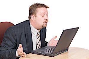 man bpowing a kiss to computer screen