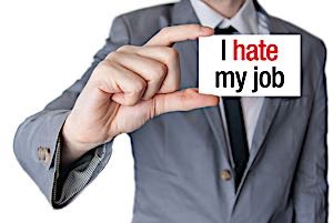 businessman holding sign that reads 'I hate my job'
