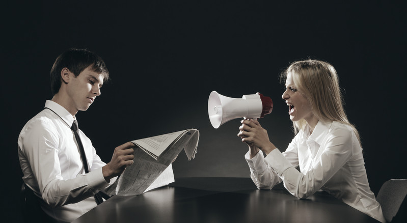 husband ignores shouting wife by reading newspaper