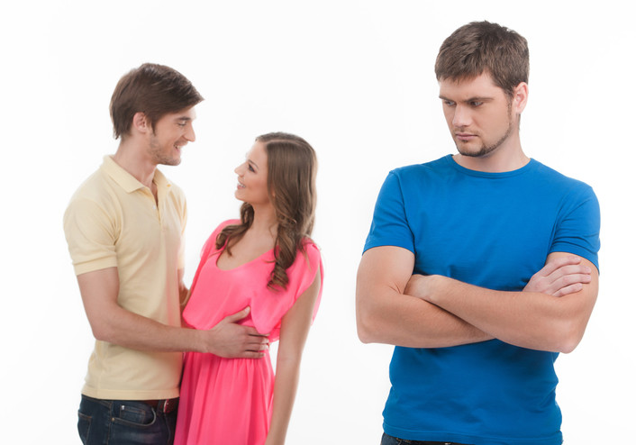 jealous angry man staring at affectionate couple